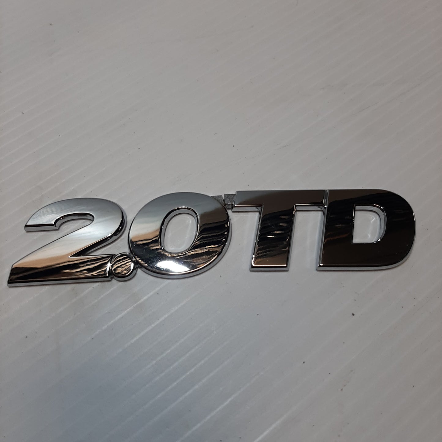 Genuine Emblem 2.O TD - Suzuki Grand Vitara | 77843-65DA1-0PG