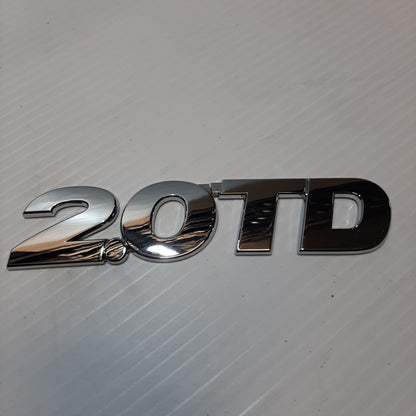 Genuine Emblem 2.O TD - Suzuki Grand Vitara | 77843-65DA1-0PG
