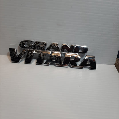 Genuine Emblem Grand Vitara - Suzuki Grand Vitara | 77841-65D21-0PG
